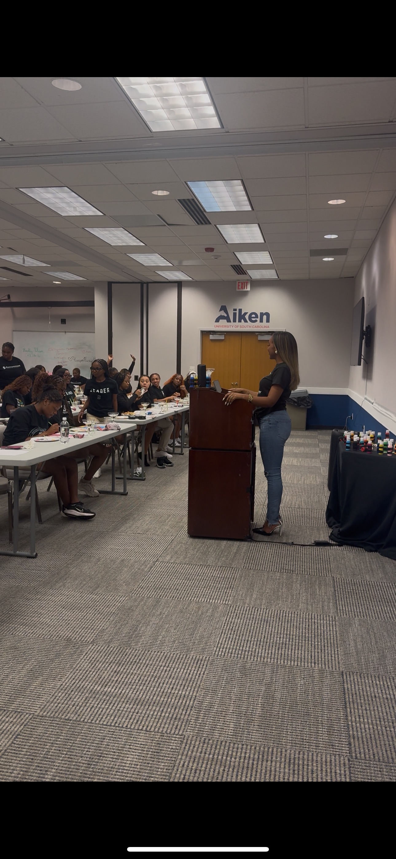 CBA founder presenting to a large group of students at a summit