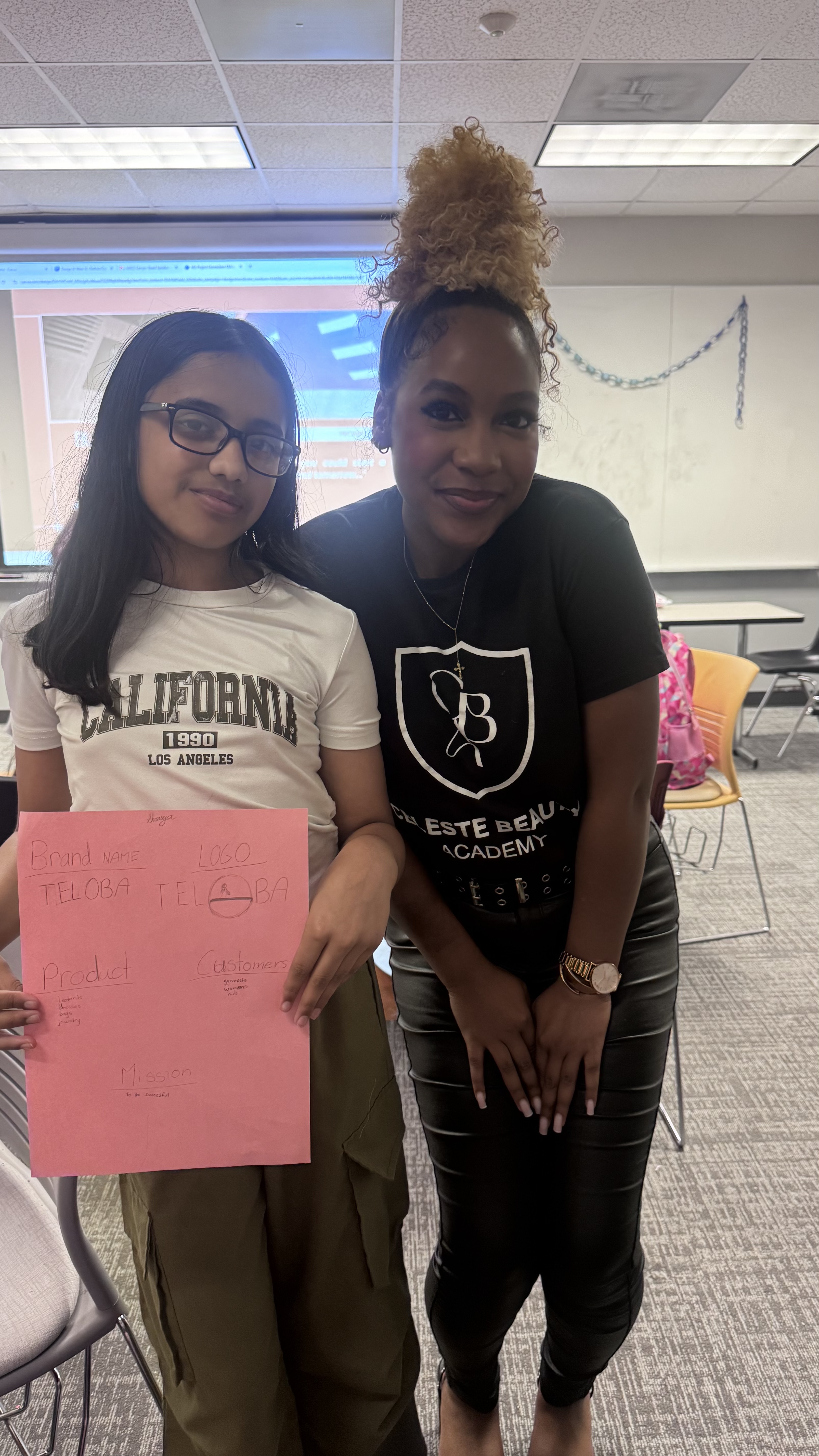 CBA student presents her TELOBA brand pitch board alongside her instructor
