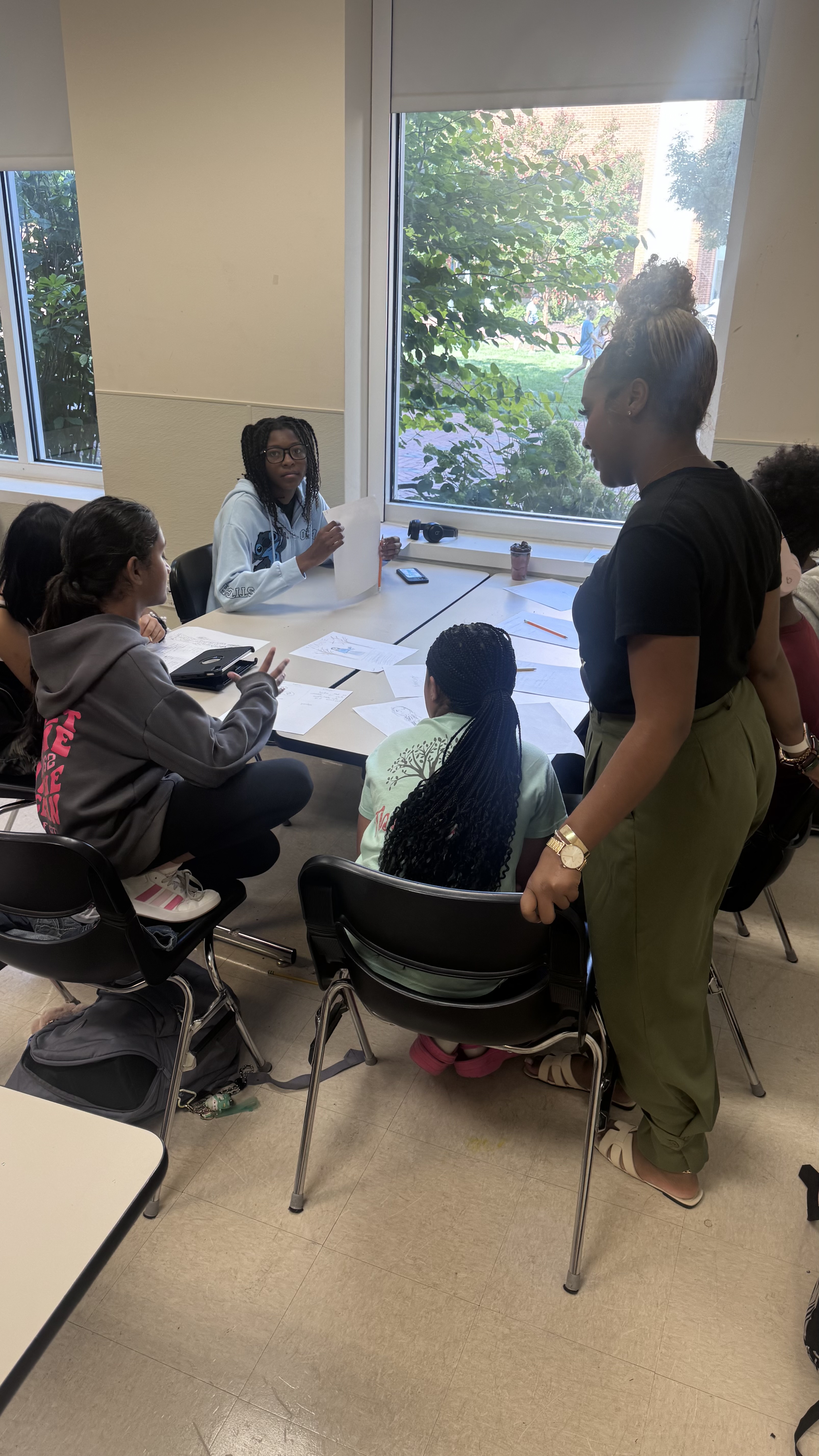 CBA students collaborating in a small-group discussion at a workshop